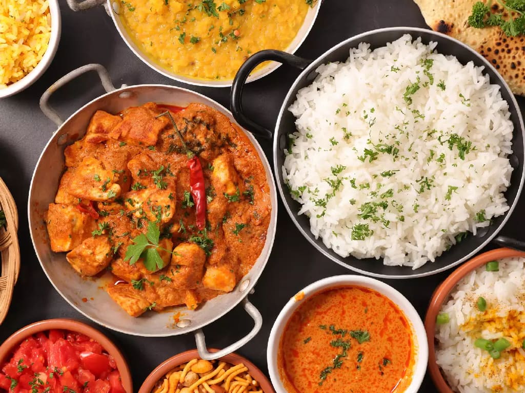 Pots of chicken curry, dal and rice