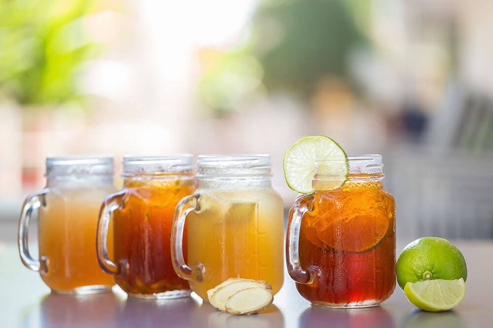 Iced tea in glass jars with lime wedges
