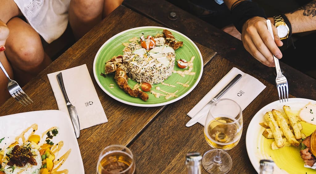 Plates of food shared at a wooden table